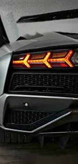 Close-up of a luxury sports car's illuminated red tail light design.