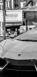 Black and white luxury sports car on urban street wallpaper.