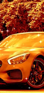 Orange luxury sports car under autumn trees, sleek design.