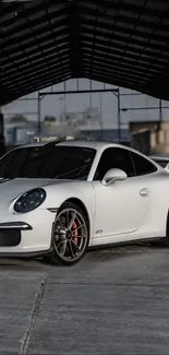 White sports car parked in a modern urban setting.