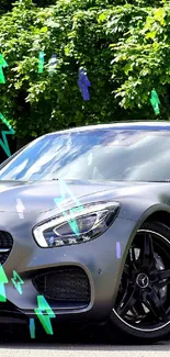 Sleek grey Mercedes AMG sports car under green trees in nature.