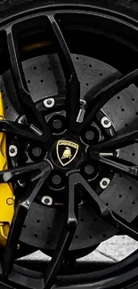 Close-up of luxury car wheel with yellow brake caliper.