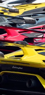 Close-up of sleek luxury sports cars in a vibrant lineup showing colorful details.