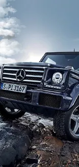 Luxury SUV navigating rugged terrain with rocky landscape.