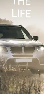 Luxury SUV driving in misty field.