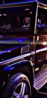 Luxury SUV illuminated by vibrant neon lights at night.