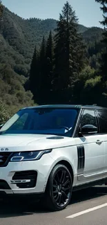 White luxury SUV parked on a scenic mountain road with forested background.