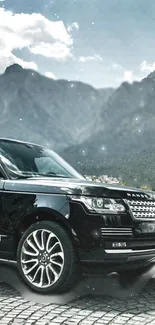 Luxury SUV with mountain backdrop, perfect for mobile wallpaper.