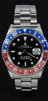 Luxury watch with colorful bezel and stainless steel bracelet on black background.