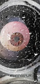 Macro close-up of a raindrop-covered lens against a soft backdrop.