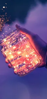 Hand holds a jar with glowing lights, set against a purple sky.