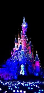 Enchanting glowing castle at night with colorful lights.