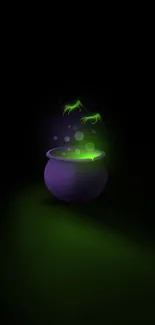 Mystical cauldron with glowing green light on dark wallpaper.