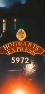 Hogwarts Express train with number 5972 glowing in orange light.