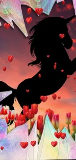 Silhouette of a unicorn with tulips and hearts against a vibrant sunset sky.