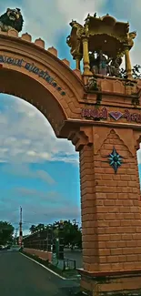 Majestic archway under a clear blue sky with lush greenery around.