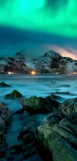 Northern Lights illuminating a mountain and seascape.