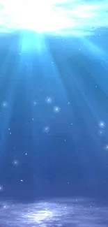 Blue ocean depth wallpaper with radiant light streaming underwater.