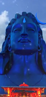 Majestic blue Shiva statue with serene sky.