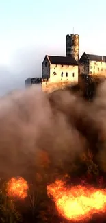 Misty castle with firey foreground wallpaper.