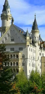 Majestic castle set against lush greenery and autumn colors.