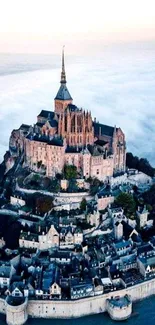 Aerial view of a majestic castle surrounded by clouds.