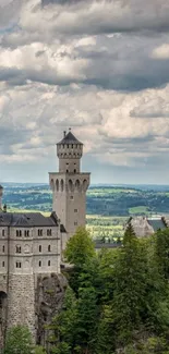 Wallpaper of a majestic castle with lush greenery under dramatic skies.