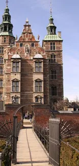 Majestic brick castle with two towers under a clear blue sky.