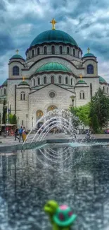 Church reflection with fountain under a dramatic sky.