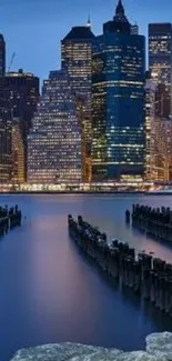 Stunning cityscape with lights reflecting on water under a night sky.