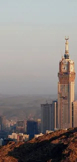 Cityscape at dusk with a prominent tower and mountain view.