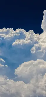 Fluffy white clouds against a deep blue sky, creating a serene mobile wallpaper.