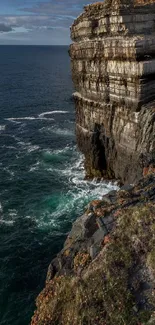 Majestic coastal cliff by deep blue ocean.