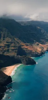 Aerial view of mountains and coast with teal ocean waters.