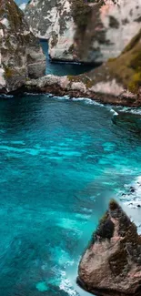 Turquoise waters with towering rock formations along the rugged coast.