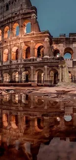 Colosseum at night with reflections in water.