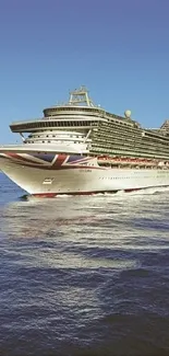 Majestic cruise ship on calm blue ocean under clear sky.