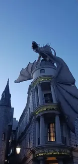 Dragon perched on Gringotts Bank against a blue evening sky.