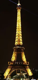 Eiffel Tower lit up against a dark sky.