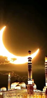 Mosque silhouette under golden crescent moon at night.