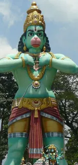 Majestic Hanuman statue against blue sky.