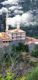 Majestic hilltop mosque surrounded by greenery and clouds.