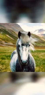 Majestic horse standing in a vibrant green meadow with mountains.