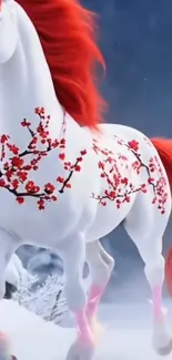 White horse with red blossoms in snow.