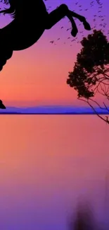 Horse silhouette with sunset and tree over water.