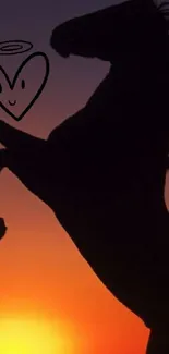 Silhouette of a rearing horse against an orange sunset sky with heart motif.