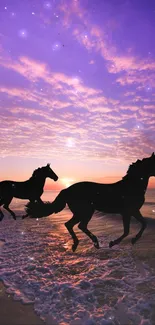 Two horses run along a beach at sunset under a purple sky.