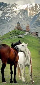 Two horses in a lush mountain landscape.