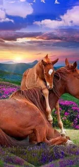 Majestic horses relax in a vivid sunset landscape.