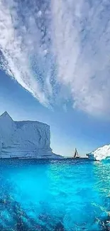 Dramatic iceberg rising from ocean under a clear blue sky.